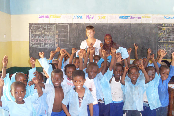 Volunteer in a classroom full of kids in Tanzania