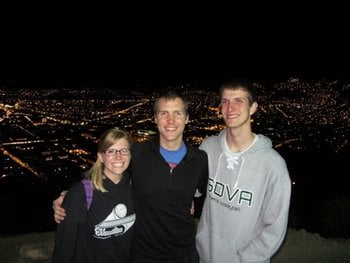 Paul and friends pose with the city lights of Cusco behind them