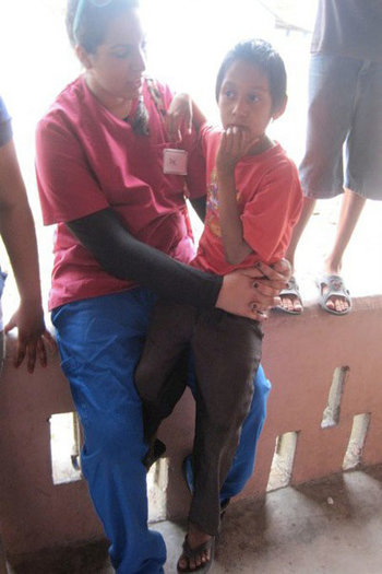 Prabjot caring for a Belizean child