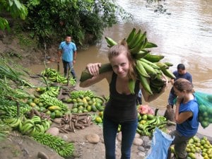 Isabelle carrying bananas as a volunteer with Ecuador Volunteer