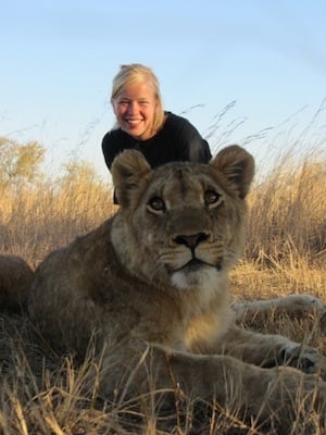 Woman posing with lion