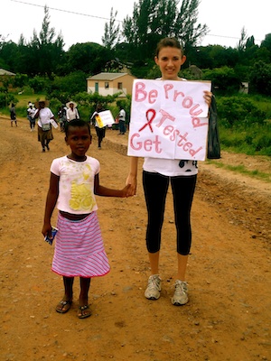 Woman with a child in South Africa holding a sign