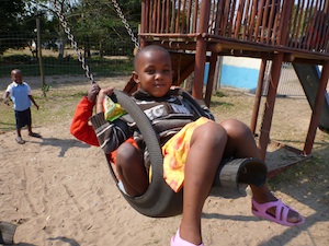 African child swinging