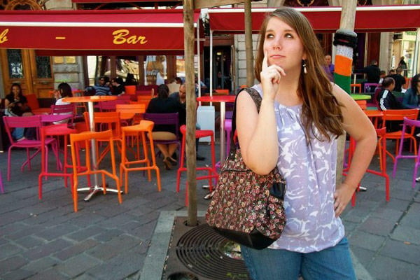 Kaitlyn in front of her favorite cafe in Place Notre Dame