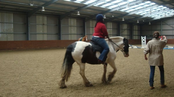 Student riding horse