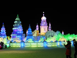 snow and ice festival palace lit up at night