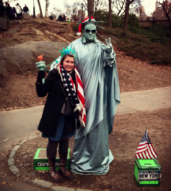 female next to the statue of liberty
