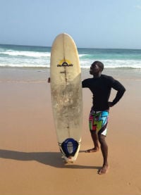 man posing on australian beach with surfboard
