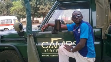guy posing by camps international van 