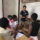 Intern teaching a group of students in Ghana 