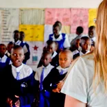 female volunteer teaching children in Kenya