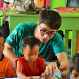 male volunteer teacher with student in the Philippines