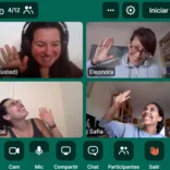 four people waving at each other on a video conference call