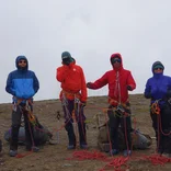 Students discuss knots on a mountaineering course.