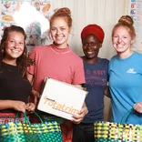Volunteer with women in Tanzania with IVHQ
