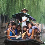 group of students smiling on a boat