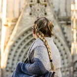 student looking back at an archway of La Sagrada Familia