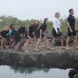 students standing in a line, recreating the evolution chart in the Galápagos Islands