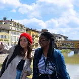 Students taking selfie with Ponte Vecchio in the background.