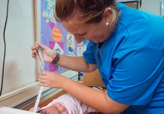 woman nurse working with baby