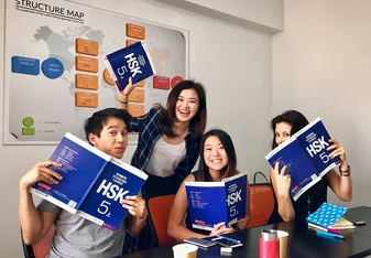 smiling-students-with-books-during-intensive-group-class