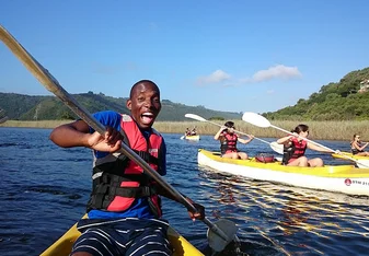 Male student on a kayak living his best life in Cape Town 
