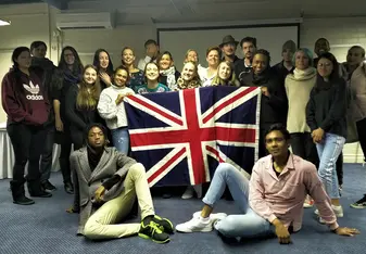Graduates pose in front the British flag in Cape Town