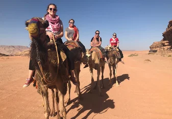 Students exploring the Wadi Rum desert by camel