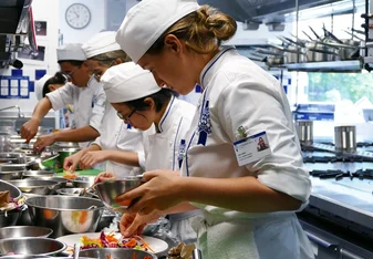 Students in the kitchen during Cuisine Diploma program at Le Cordon Bleu