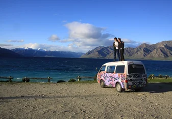 People standing on top of an adventure van in New Zealand