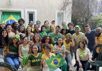 Students, faculty, and staff posing for a photo during a World Cup 2022 watch party
