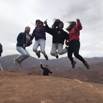 We hiked up a mountain and did a jump shot on top of a mountain, while one of our group leaders does a funny pose. 