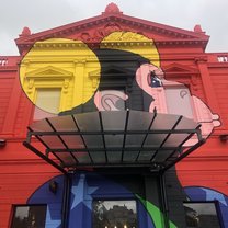 Building face of the 'Centro Cultural'--mural of a colorful monkey
