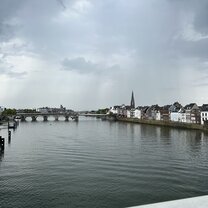 The river Maas with the beautiful old city buildings and bridge 
