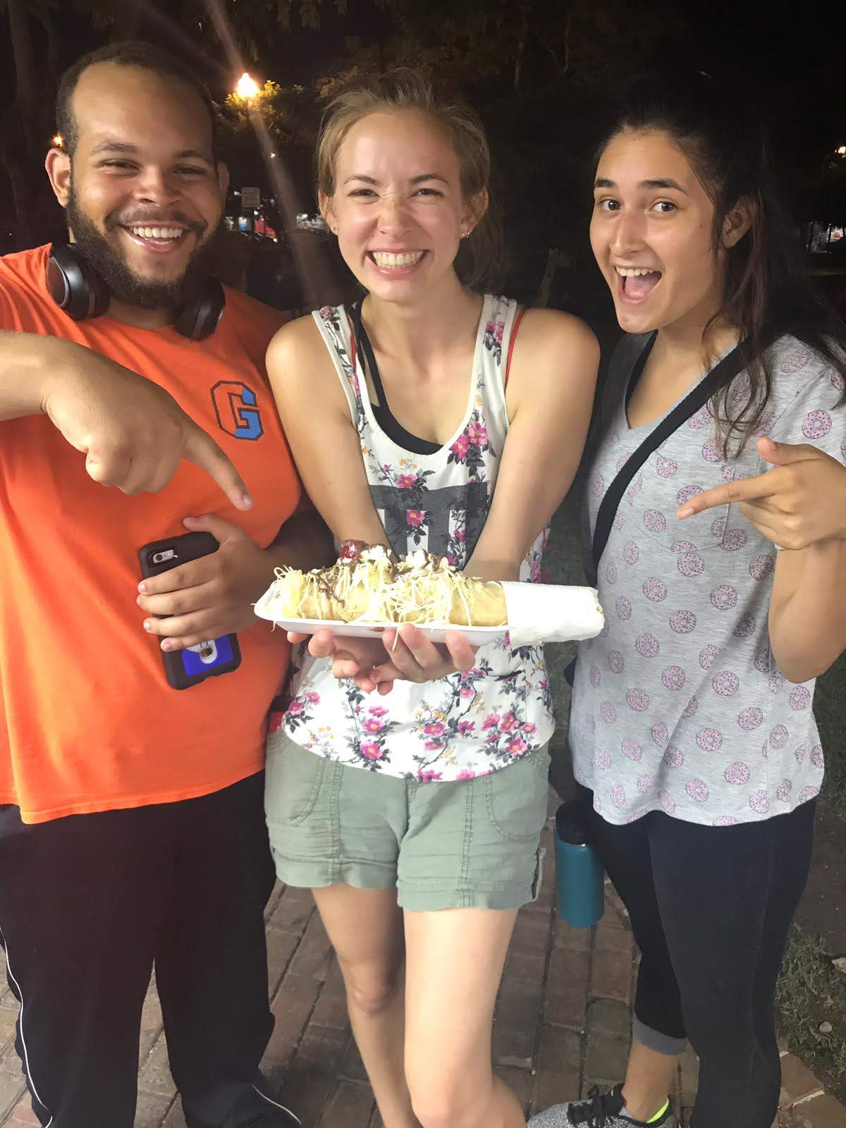 Marquesitas three students holding a marquesita