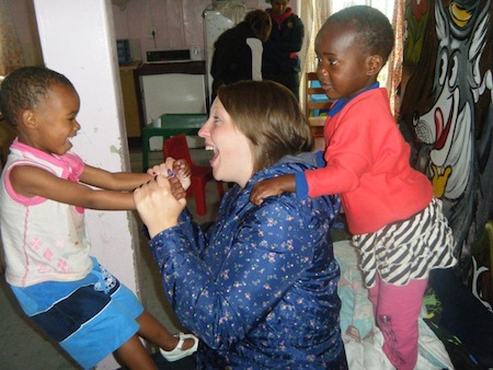 South African children playing with a GVI volunteer