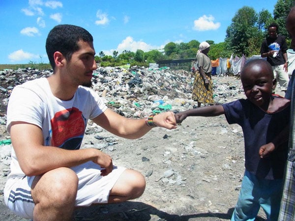 Rayan bumping fists with one of his students