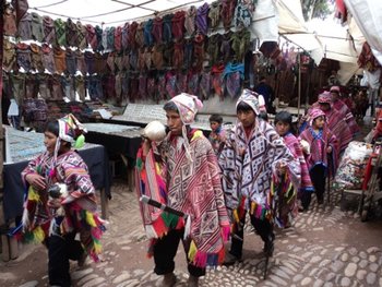 Children walking through the local market at Pisac