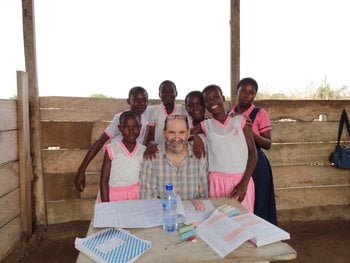 Matthew posing with a group of schoolchildren 