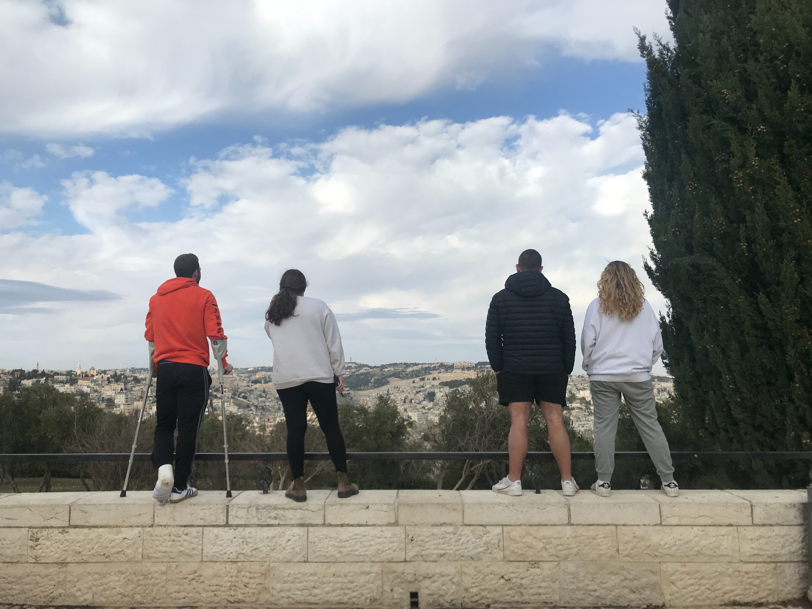 Friends looking out over the Tayelet at a view of the Old City