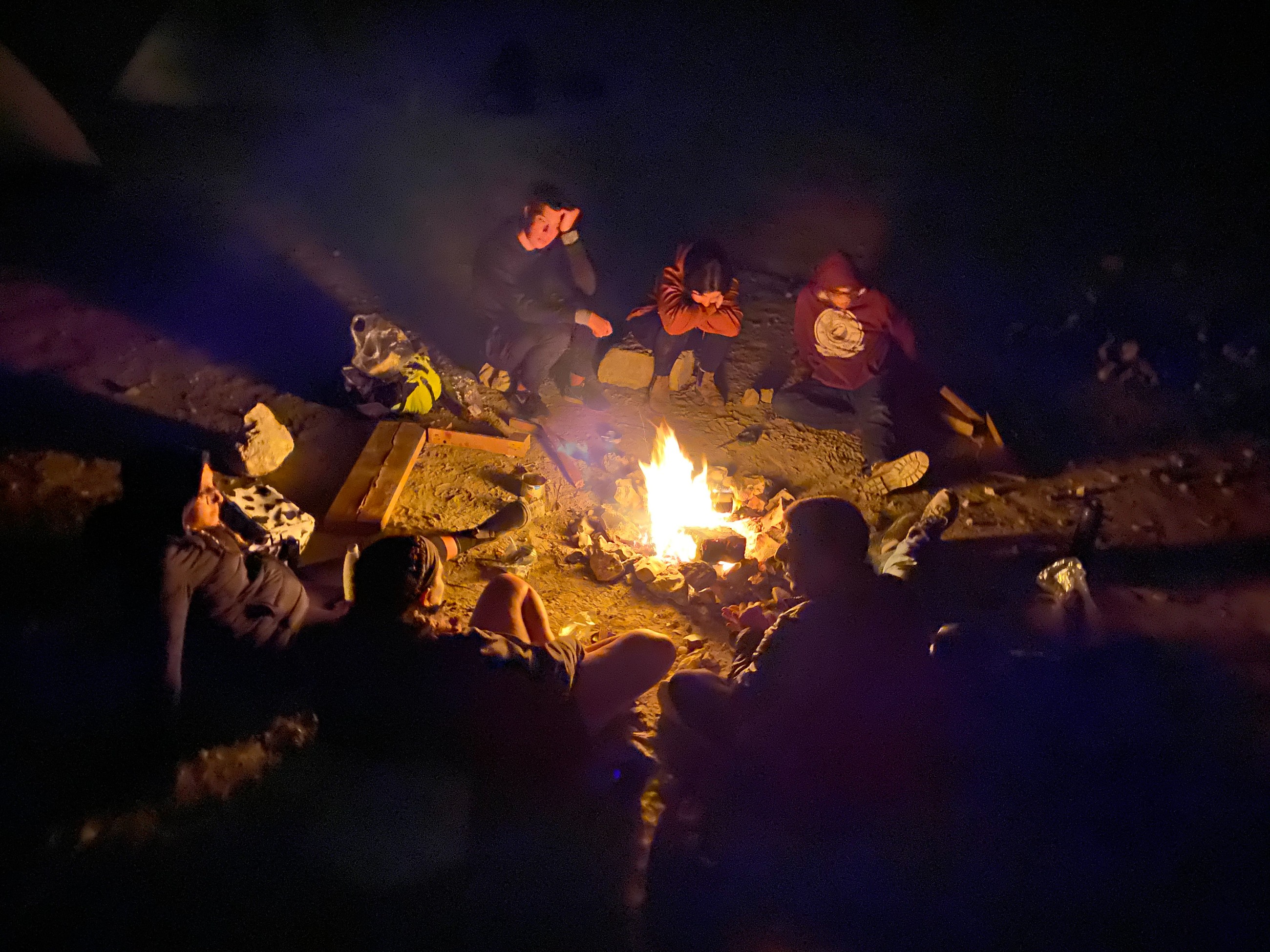 My friends and I sitting around a camp fire
