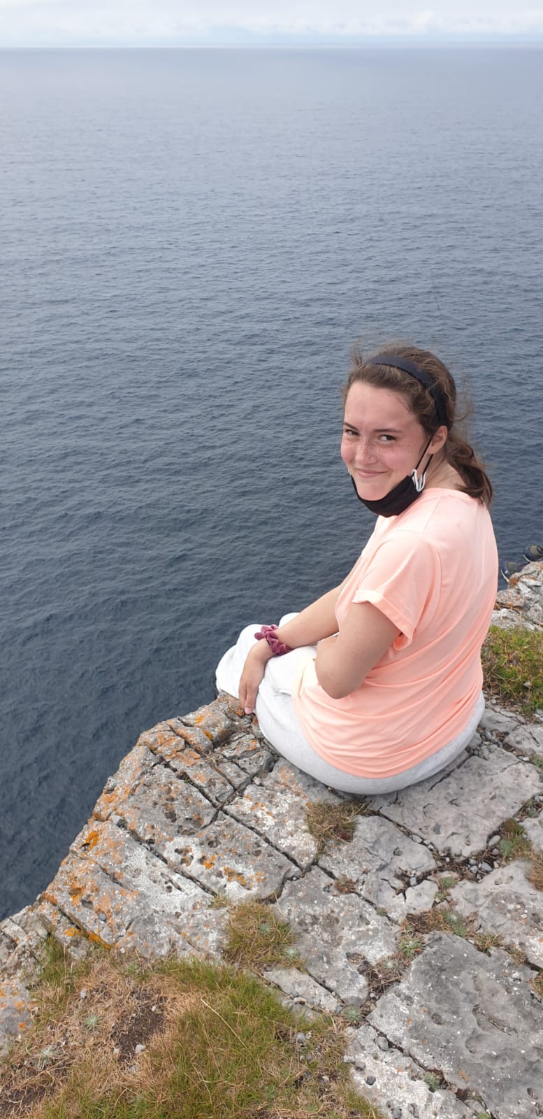 Sitting on the edge of a cliff enjoying every moment