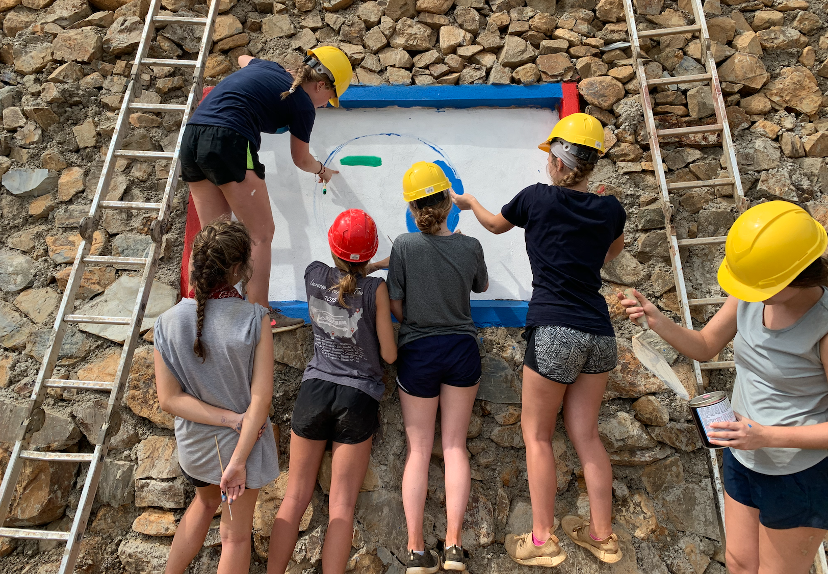 This was the final day working on our community service project! We had just finished building this wall and were in the process of painting a mural!