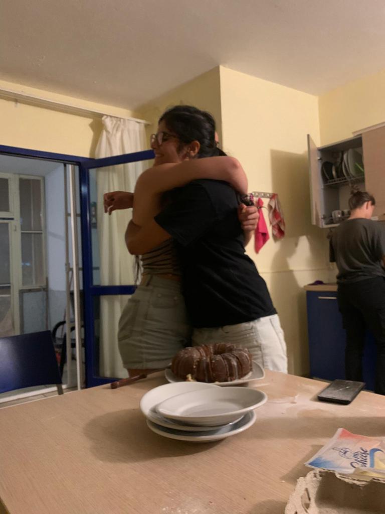 Hugging Débora because she made a "goodbye-cake"