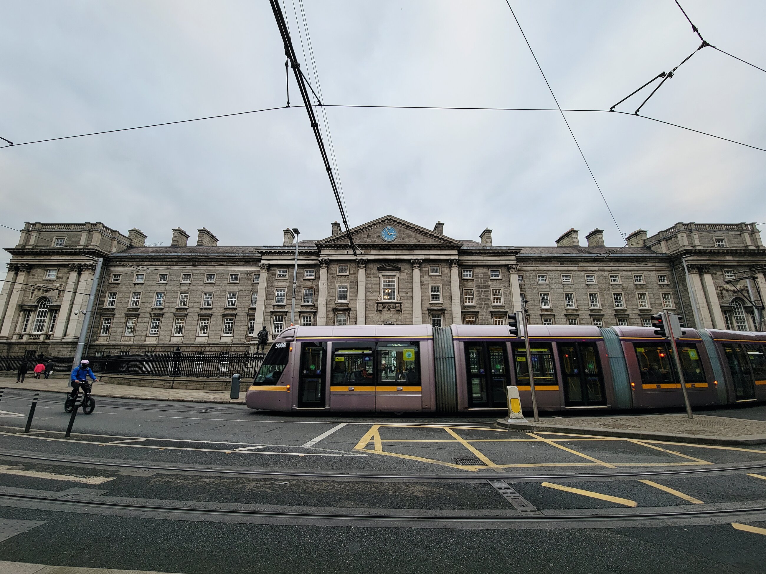 Trinity front gates with Luas tram