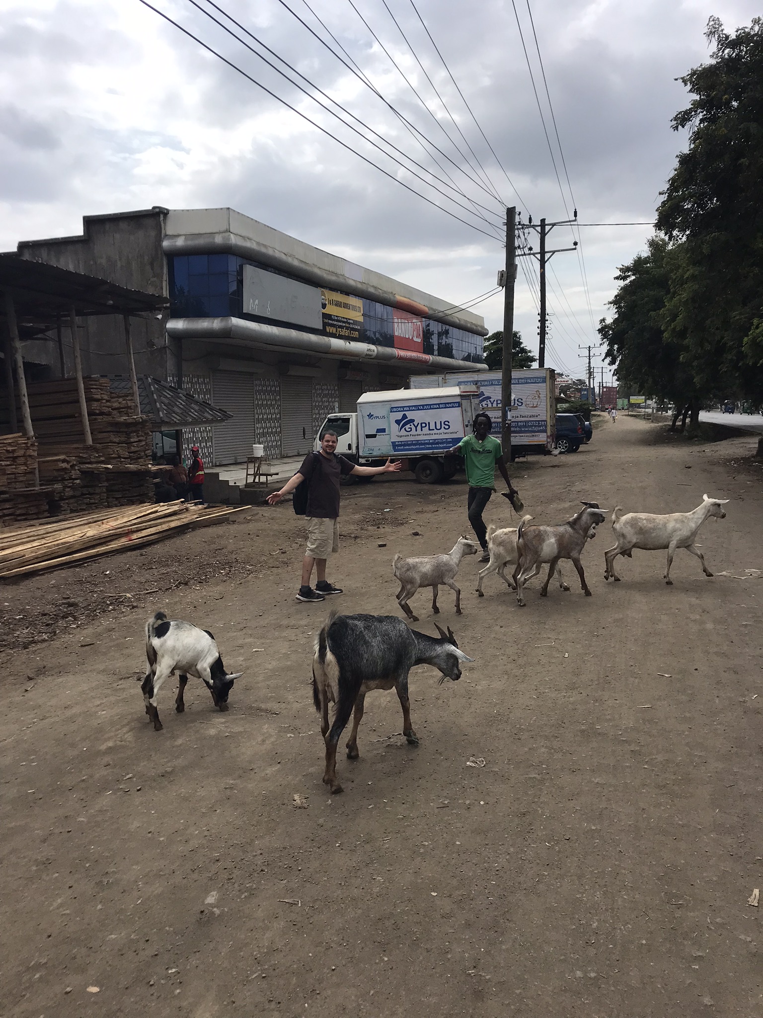 My roommate and local named John with goats on side of road