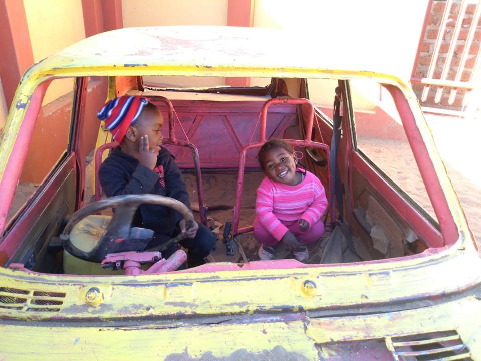 Children in a toy car
