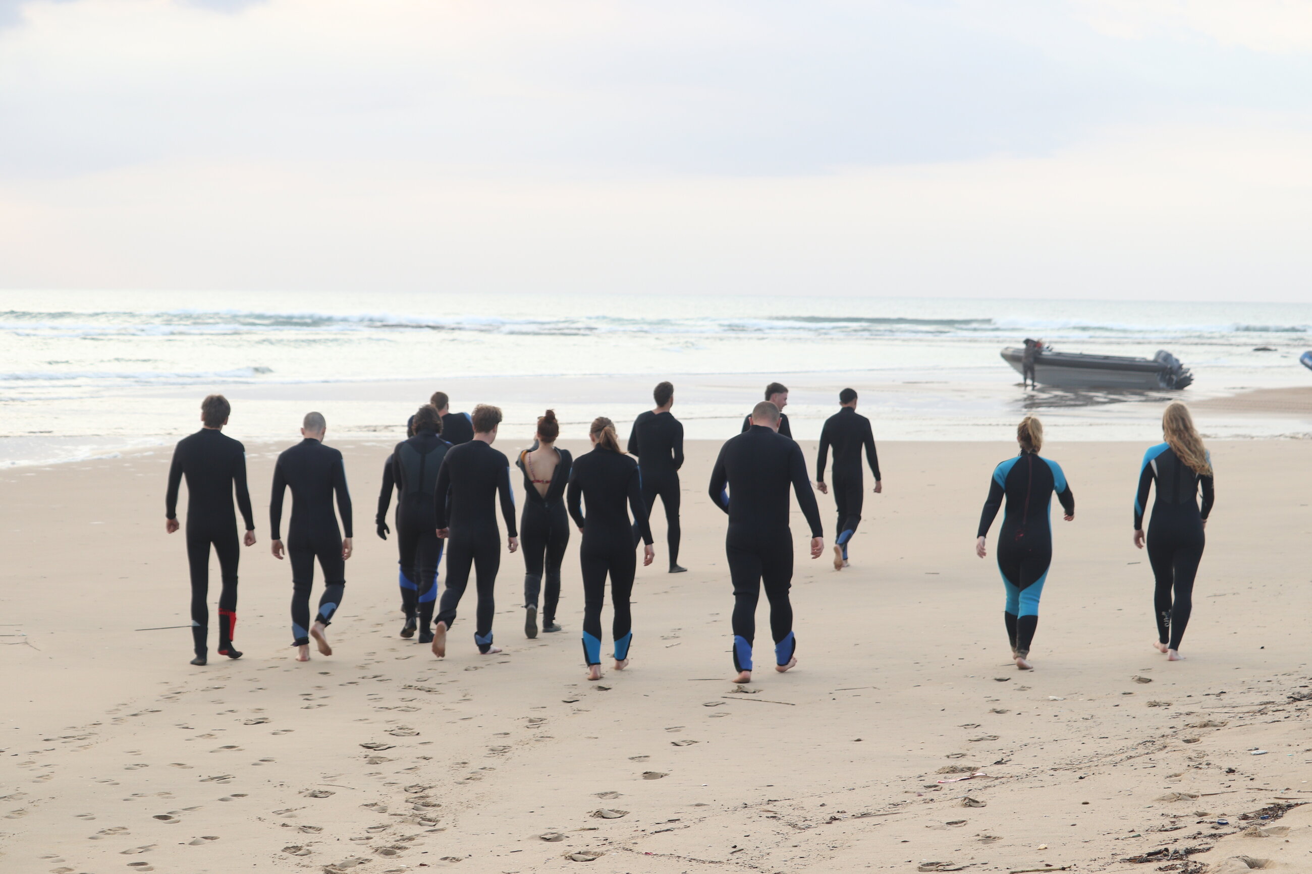 Warriors group walking to the boat at Sodwana bay, on the way to scuba dive. 