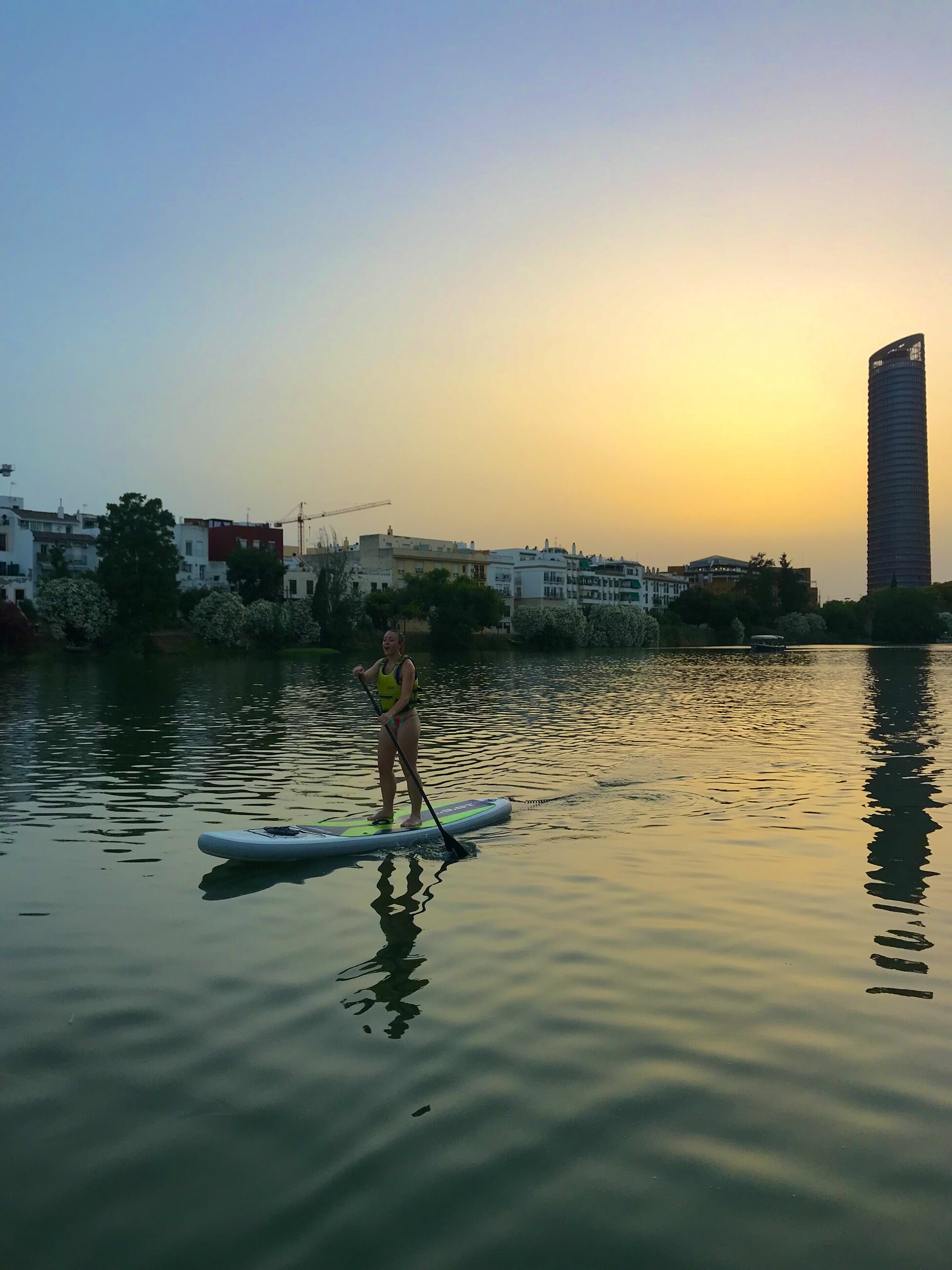Paddle boarding on the Guadalquivir river at sunset