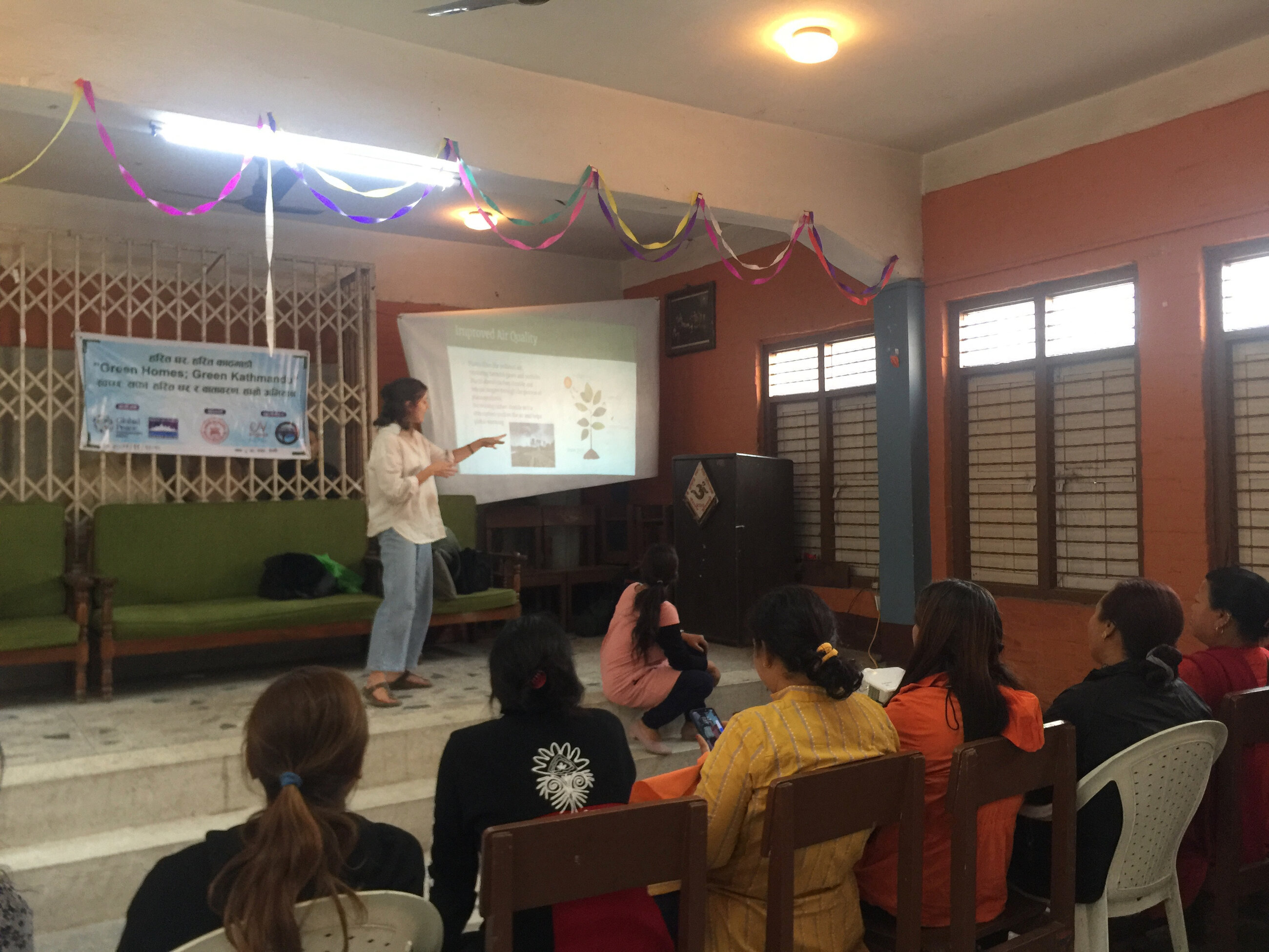 A presentation on the environmental benefits of having a household garden to local women